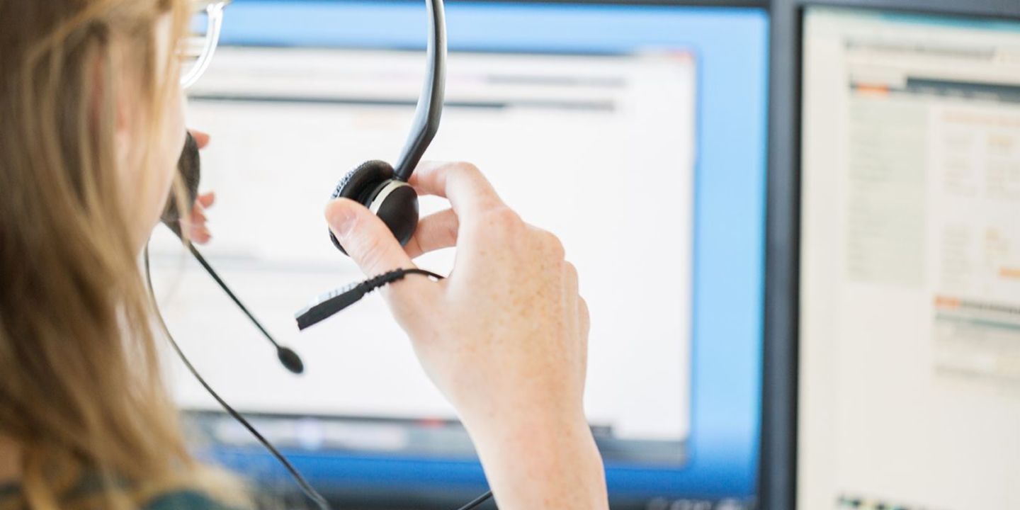 Artificial intelligence in the call center. A call center agent puts on her headset.