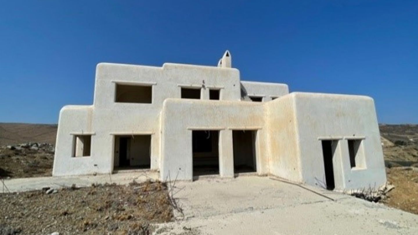 Photo of a complex with several unfinished villas on Mykonos that EOS is refurbishing to sustainable standards.